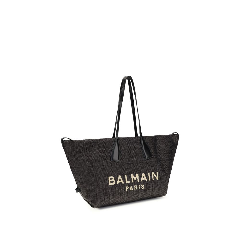 Side view of Balmain Track Tote Bag in Black Raffia and Calfskin from The Exclusive Line Singapore.