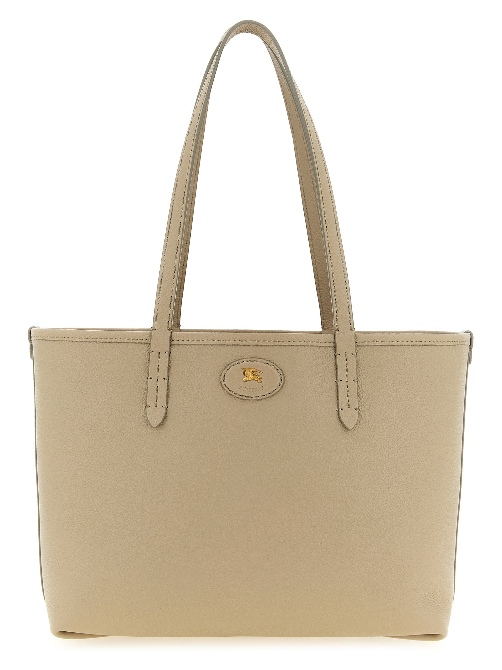 Burberry Small Reversible Bloomsbury Tote in Mushroom Beige grainy calf leather, highlighting the archival metal Knight stamp and elongated top handles from The Exclusive Line Singapore.
