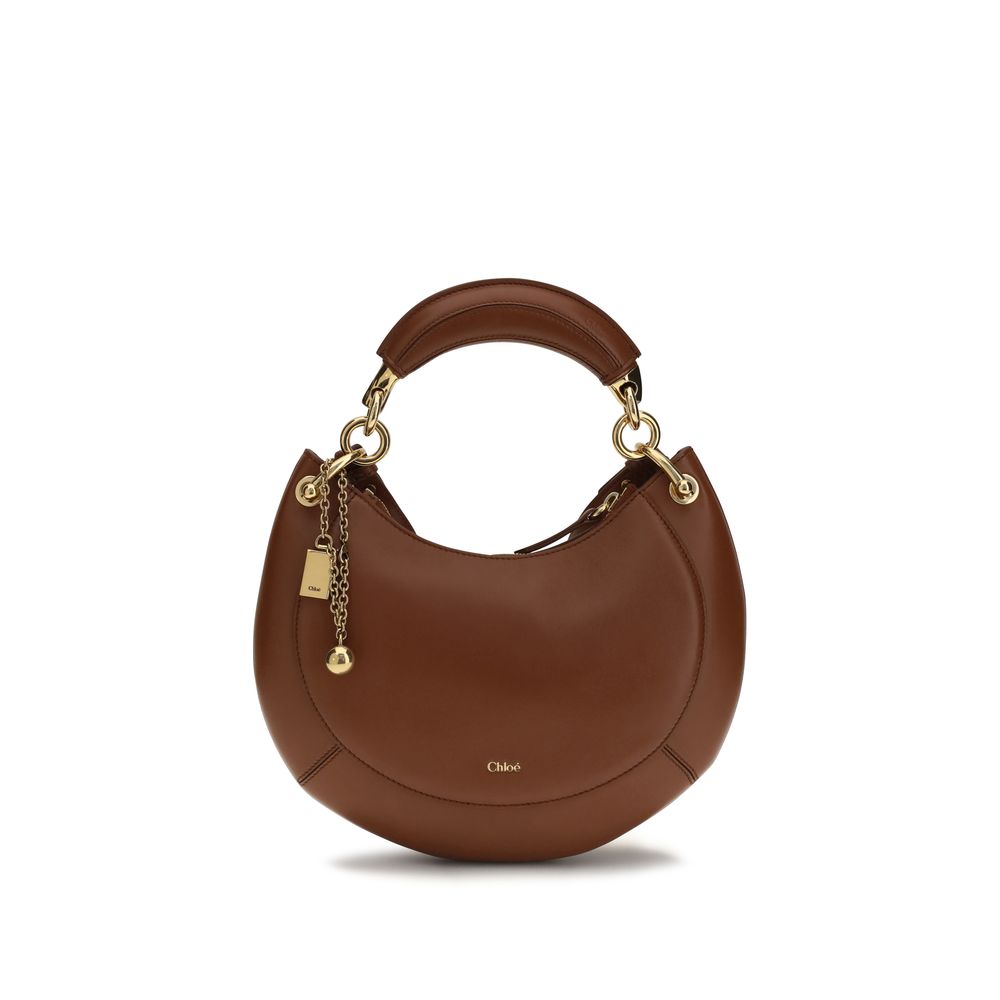 Chloé Banana small hobo bag in blushy brown soft nappa lambskin leather featuring a crescent silhouette, banana-shaped handle, and gold-tone logo charms from The Exclusive Line Singapore.