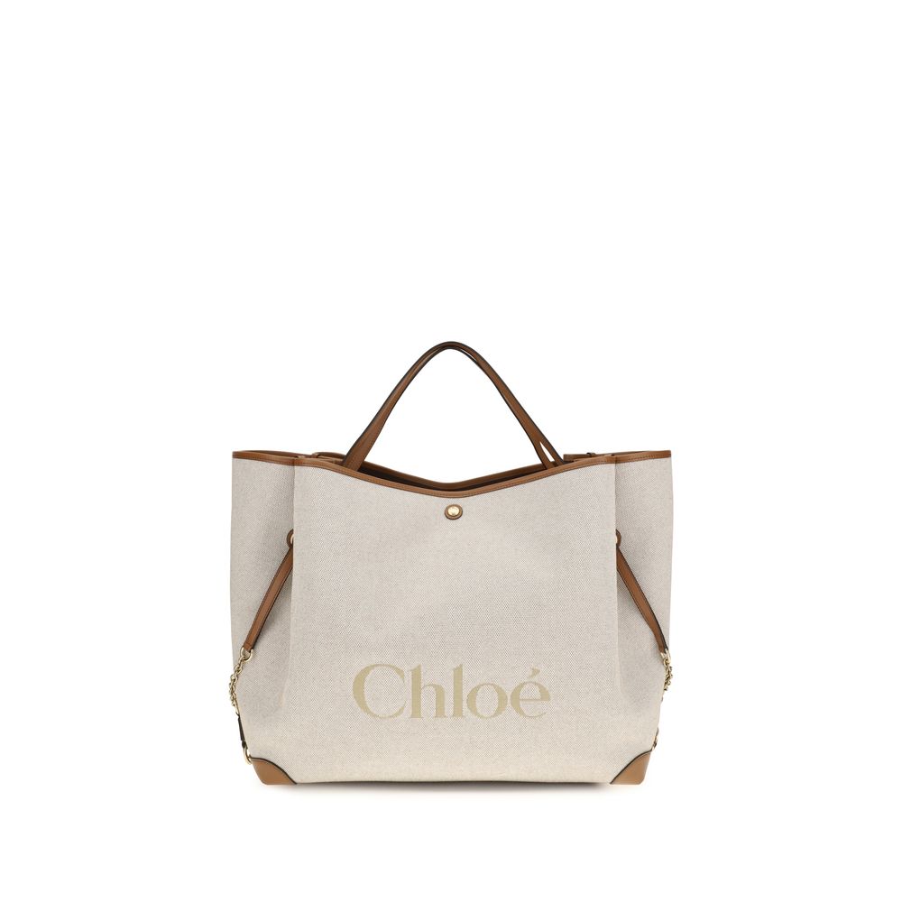 Chloé Clover double carry bag in clay brown cotton canvas featuring a spacious silhouette, an oversized Chloé logo, brown calfskin trim, and gold-tone hardware.