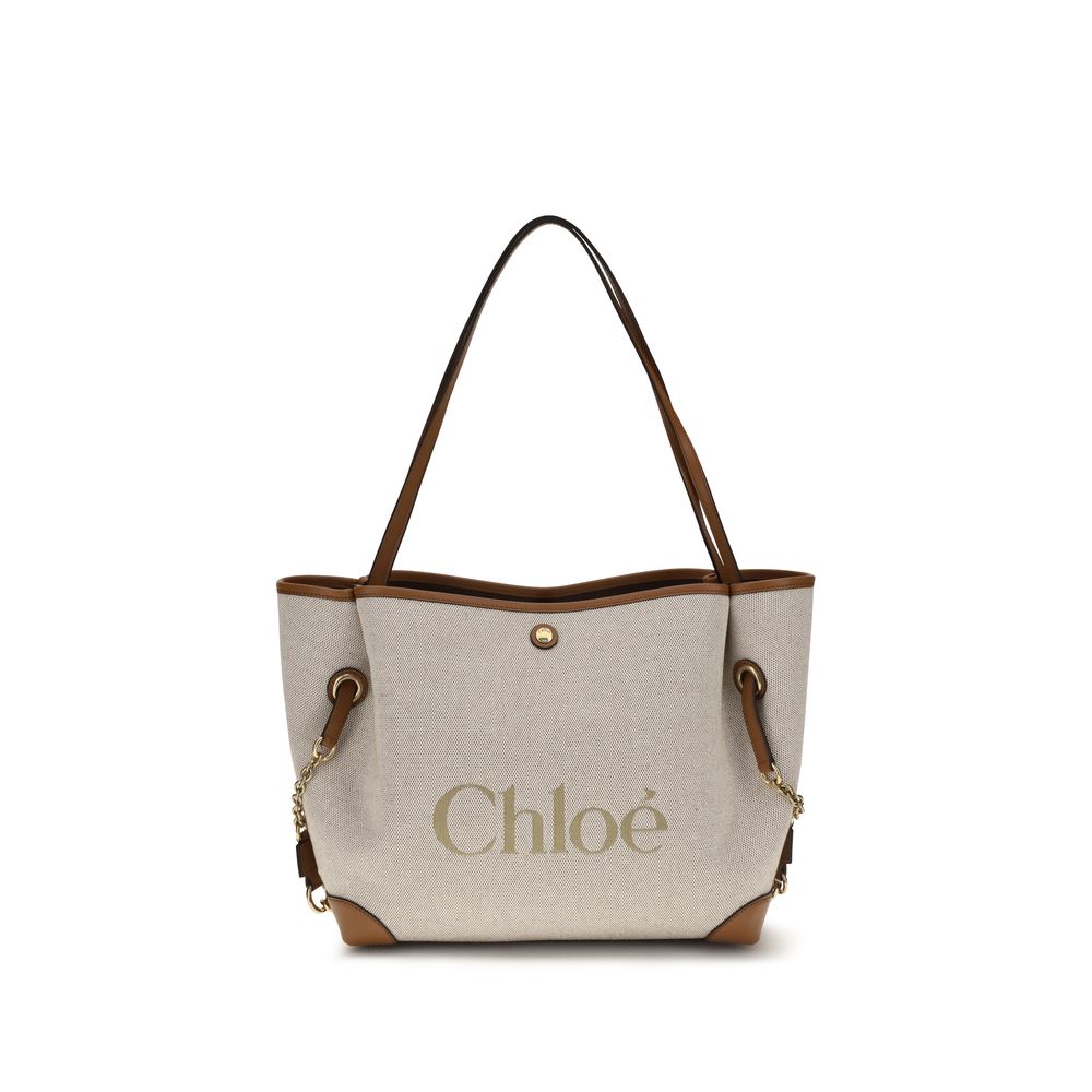 Chloé Clover double carry bag in clay brown cotton canvas featuring a spacious silhouette, an oversized Chloé logo, brown calfskin trim, and gold-tone hardware.