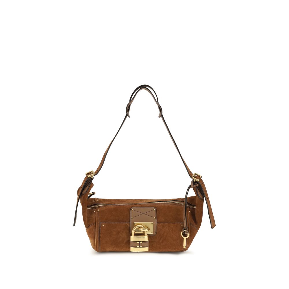 Chloé Paddington crossbody hobo bag in vintage brown suede calfskin leather featuring the iconic oversized metal padlock, studs, and an adjustable shoulder strap from The Exclusive Line Singapore.