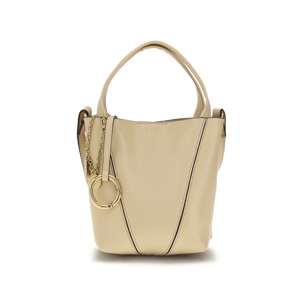 Chloé Spin small tote bag in beige shiny grained cowhide featuring graphic lines, dual handles, and a gold-tone chain with the signature Horse Medal from The Exclusive Line Singapore.
