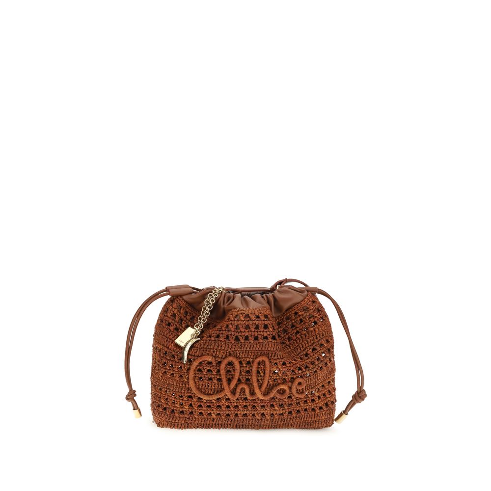 Chloé Summer Banana mini drawstring bag in clay brown hand-woven raffia and lambskin leather featuring an embroidered signature and gold-tone charms from The Exclusive Line Singapore.