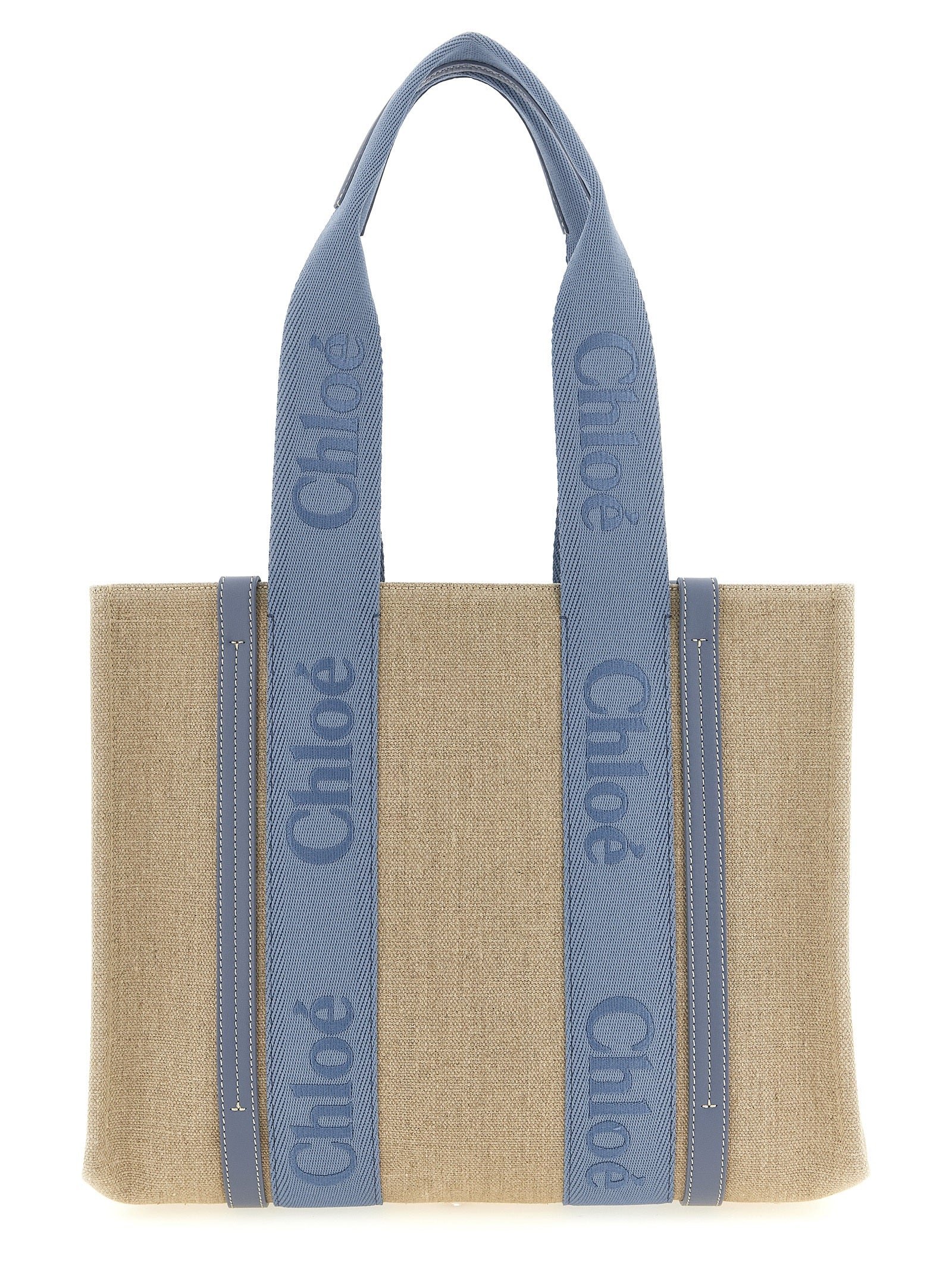 Chloé Woody medium tote bag in natural linen canvas featuring ashes blue shiny calfskin leather strips and matching embroidered logo webbing ribbons from The Exclusive Line Singapore.