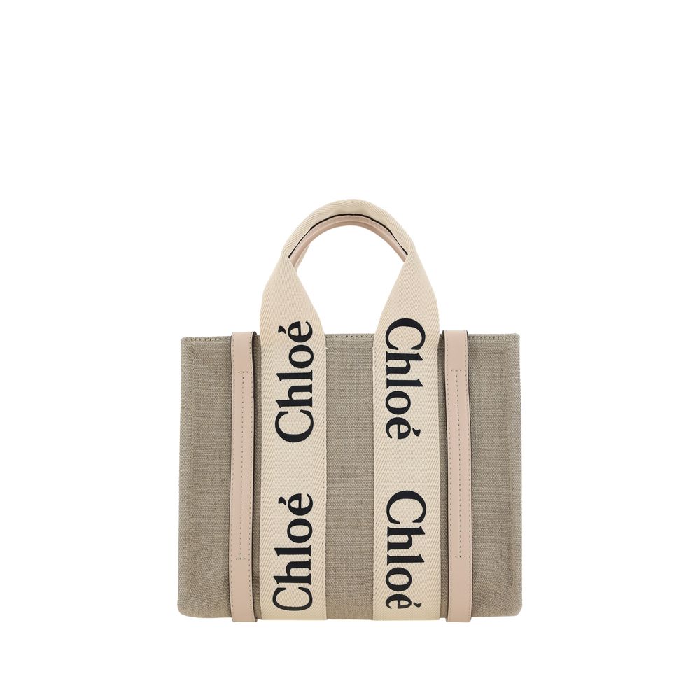 Chloé Woody small tote bag in cement pink linen canvas featuring matching shiny calfskin leather strips and the signature embroidered logo ribbon from The Exclusive Line Singapore.