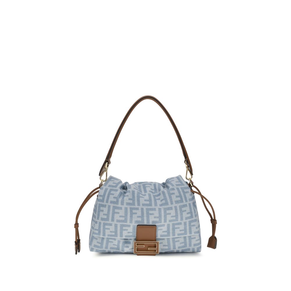 Fendi Medium Mamma Baguette bag in light blue FF monogram denim featuring a soft, deconstructed silhouette, sellier brown leather trim, and a gold FF clasp.