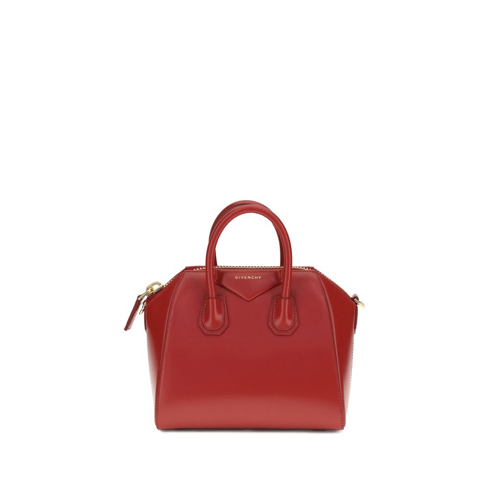 Givenchy Mini Antigona Bag in vibrant vermillon red box calfskin leather featuring a pentagonal patch with gold-finish embossed signature.