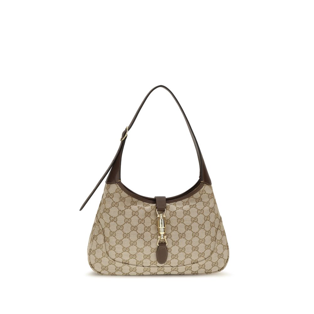 Gucci Jackie 1961 Medium Shoulder Bag in sand and brown GG canvas featuring dark brown leather trim and the signature gold-toned piston closure.