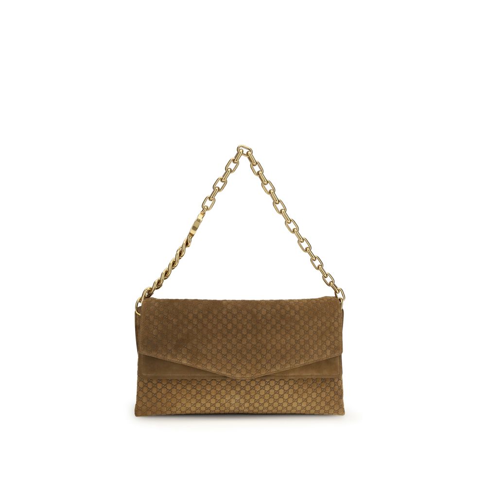 Gucci Large shoulder bag in camel brown GG embossed suede featuring a gold-tone chunky chain strap and magnetic flap closure – The Exclusive Line Singapore.