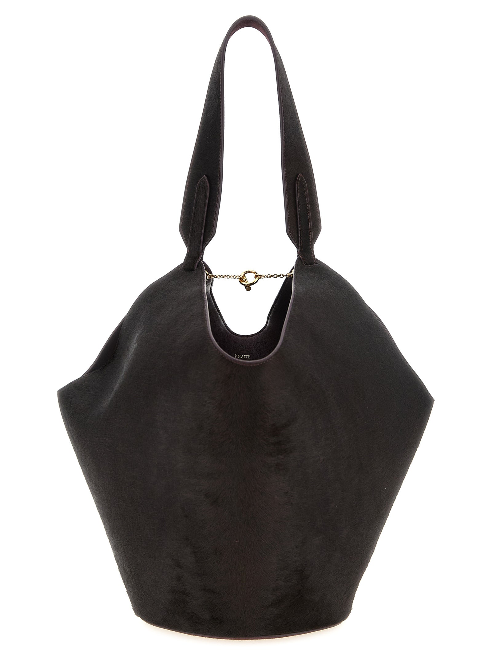 Khaite Small Lotus Tote in a deep Rouge Noir colorway, highlighting the contrast between the plush suede paneling and hair-on calfskin texture, featuring a delicate gold-tone interior toggle.