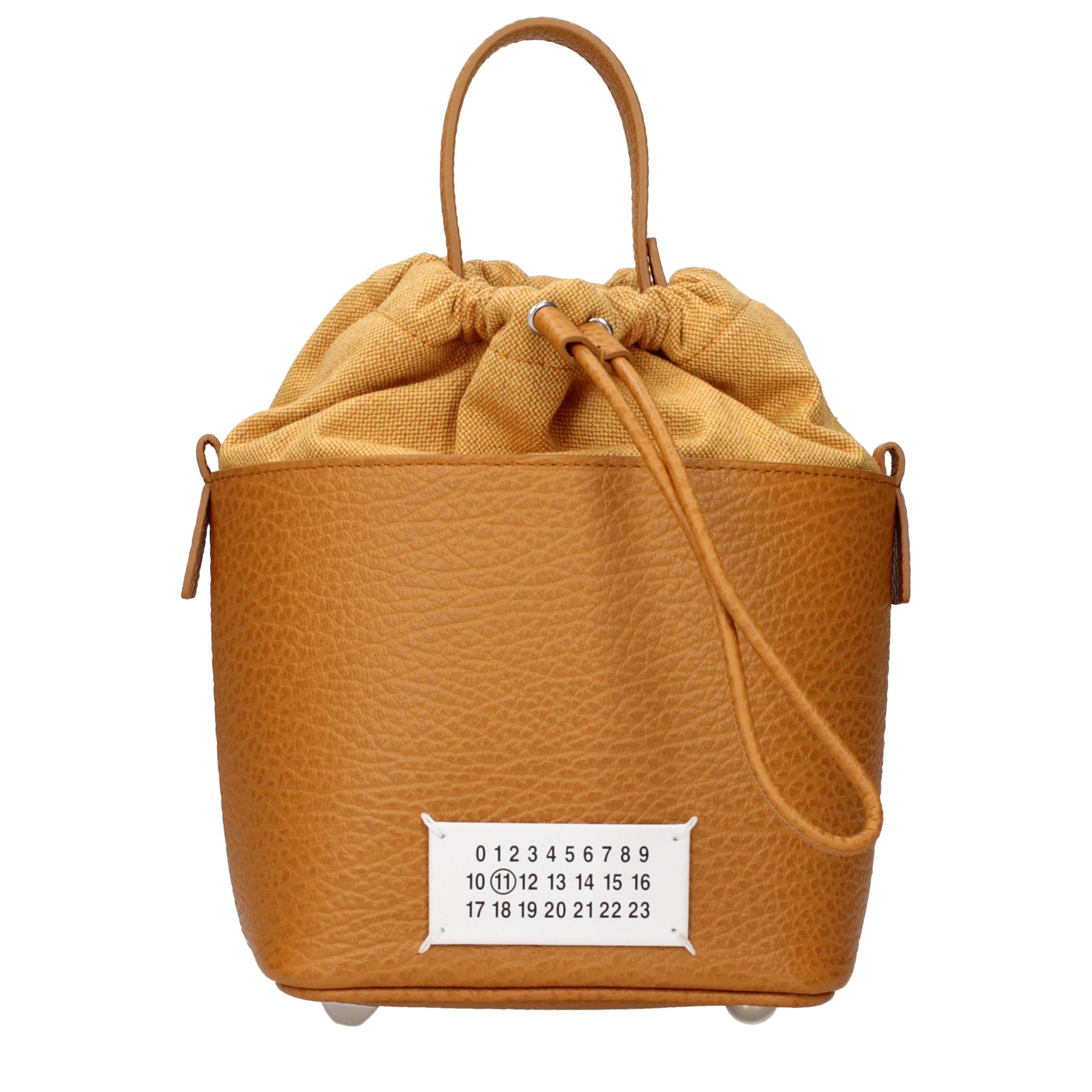Maison Margiela 5AC Small Bucket Bag in tan grainy leather featuring contrast canvas drawstring top, chain strap, and numeric logo label.