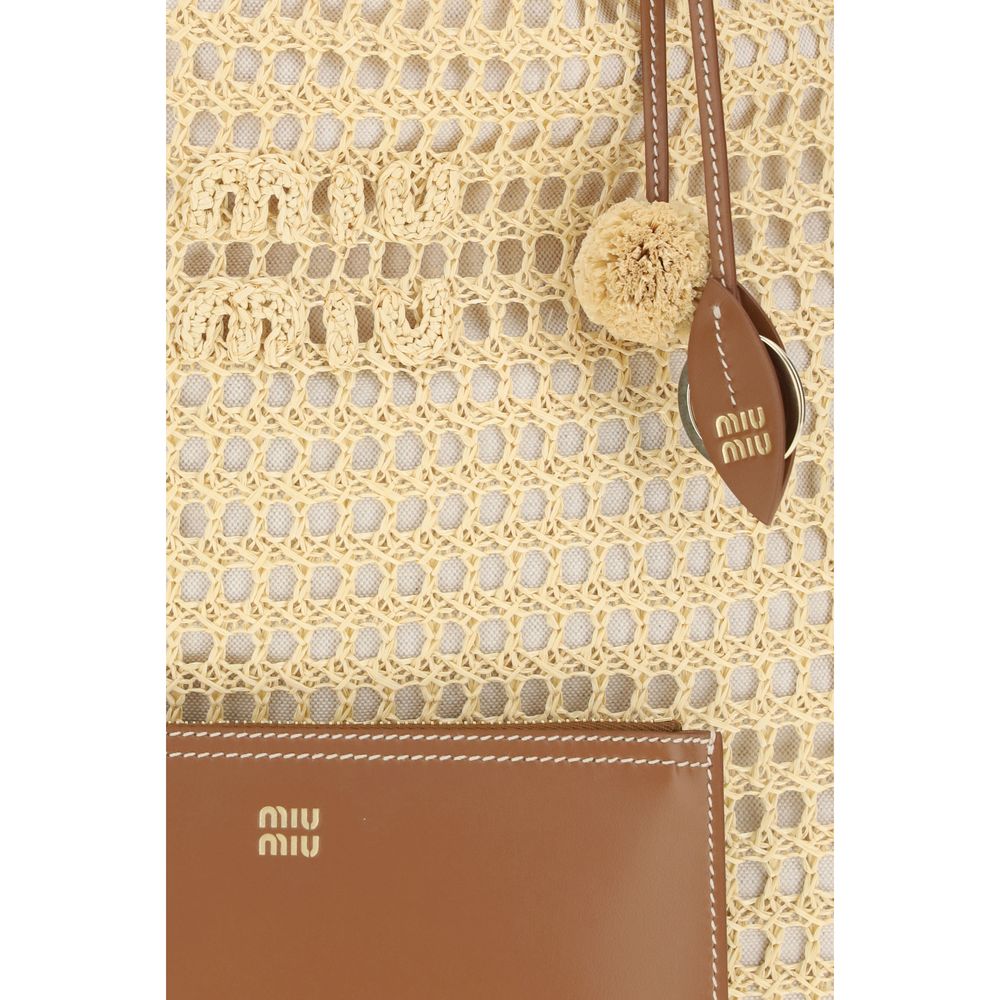 Close up of Miu Miu Ivy crochet tote bag in Sand featuring a net design and leather interior pouch from The Exclusive Line Singapore.