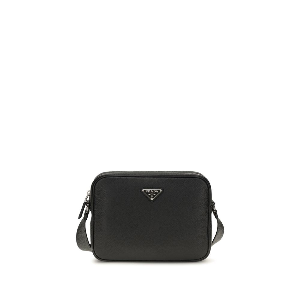 Prada black calfskin leather shoulder bag with enameled metal triangle logo and adjustable leather crossbody strap.