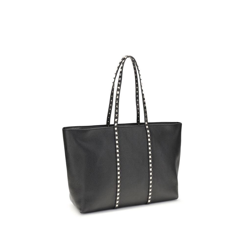 Side view of Valentino Garavani Rockstud Shopping Bag in Black Grainy Calfskin with Platinum Studs - Luxury Tote at The Exclusive Line Singapore.