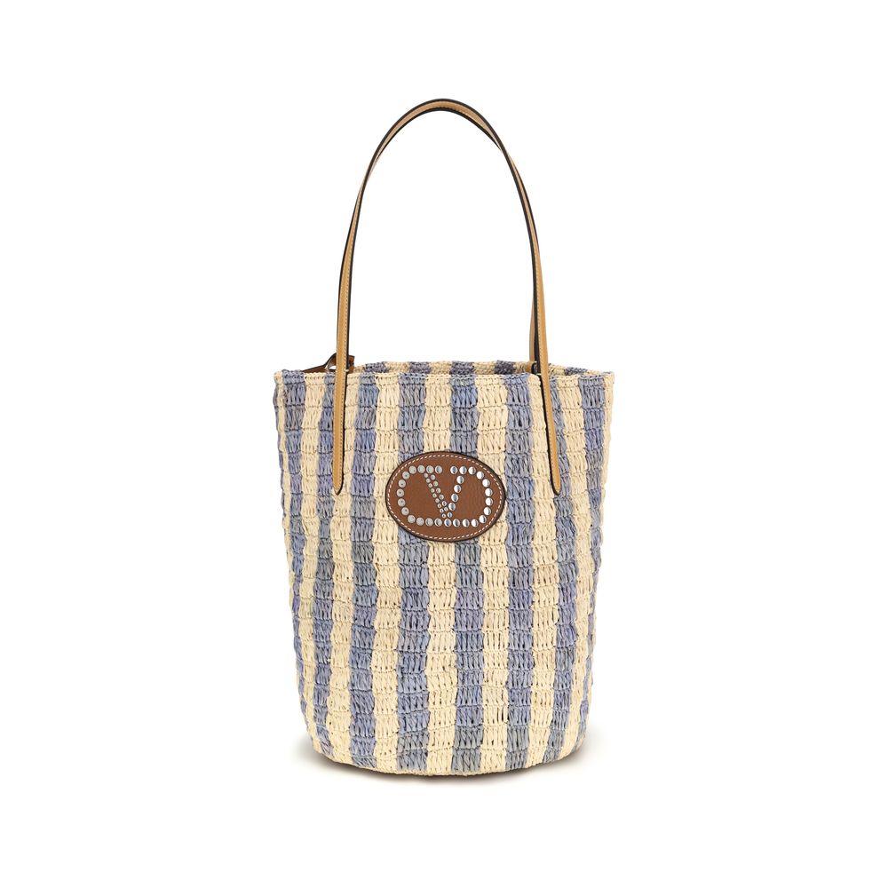 Valentino Garavani Striped Raffia Shopping Bag in Natural and Azure Blue with VLogo Leather Patch - available at The Exclusive Line Singapore.