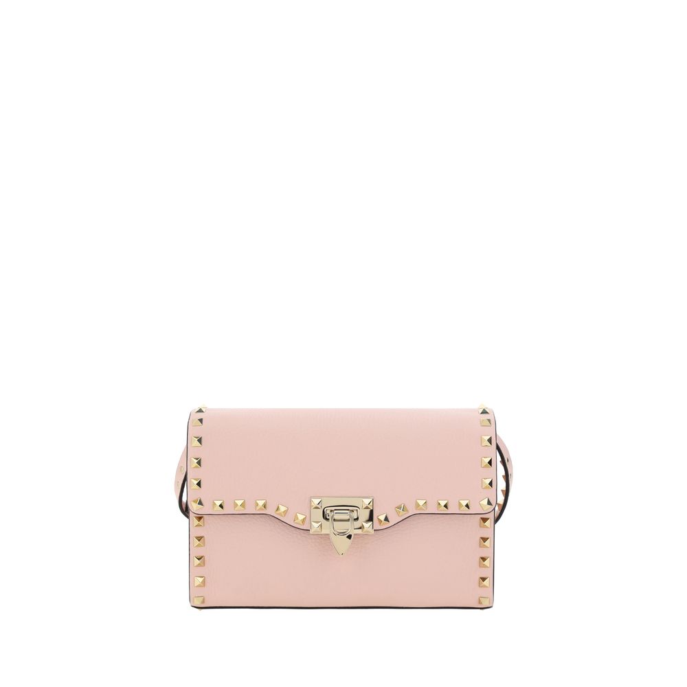 Valentino Garavani Rockstud small shoulder bag in pink grainy calfskin leather with platinum studs and hook closure.