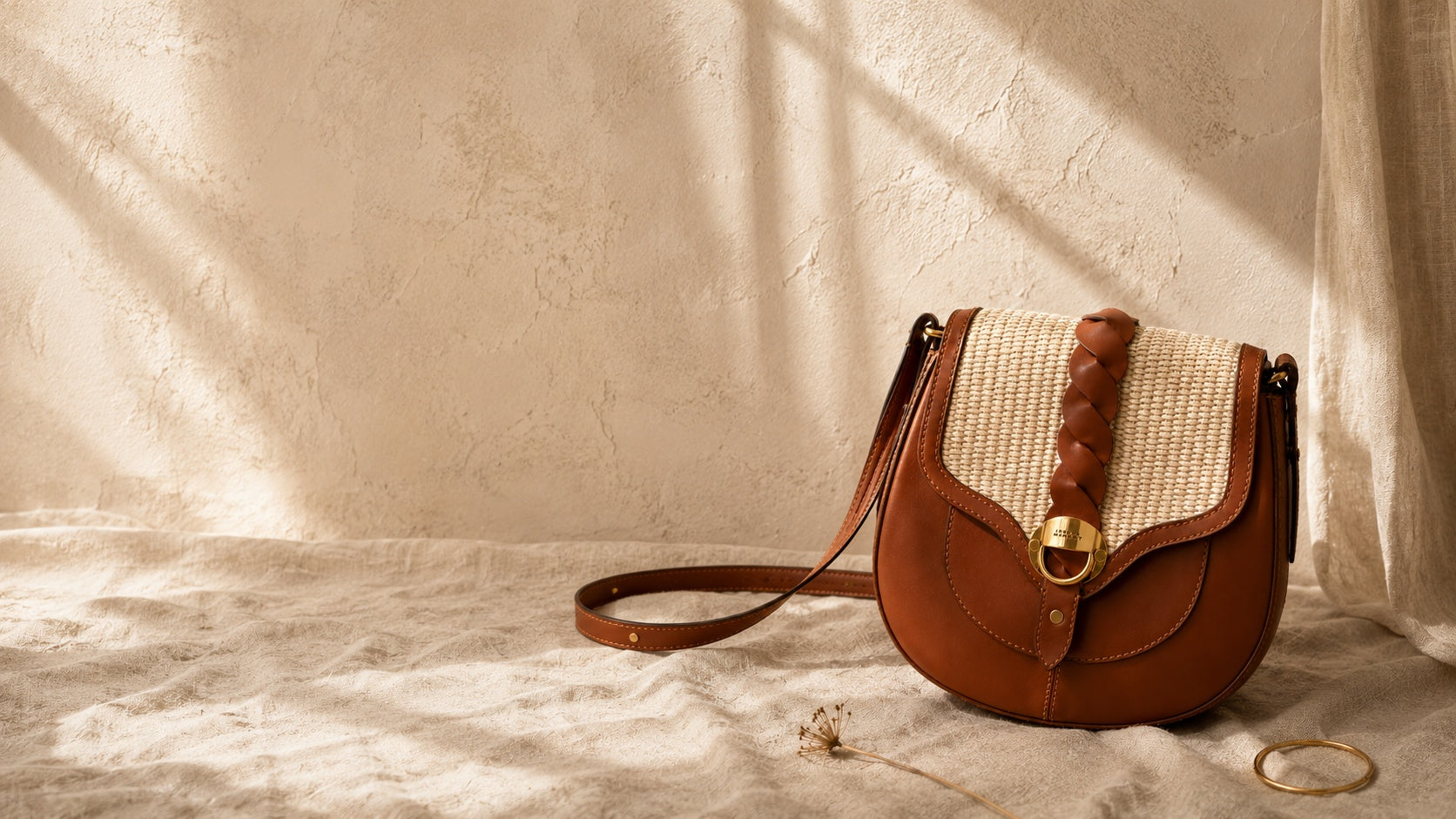 Isabel Marant Altay Small shoulder bag in brown calfskin leather and woven raffia with adjustable strap, from The Exclusive Line Singapore.