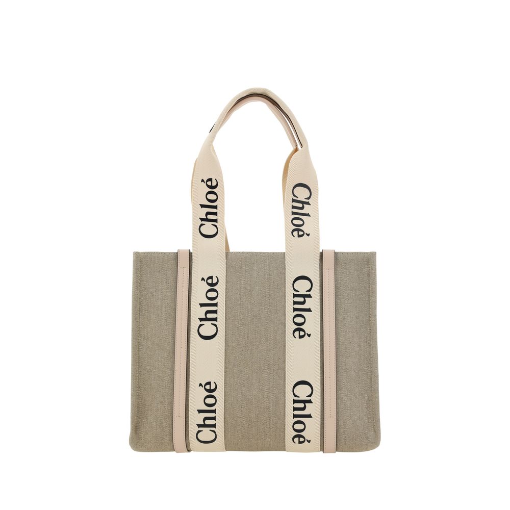 Chloé Medium Woody tote bag in white linen canvas and cement pink calfskin leather trim featuring the signature Chloé logo ribbon.