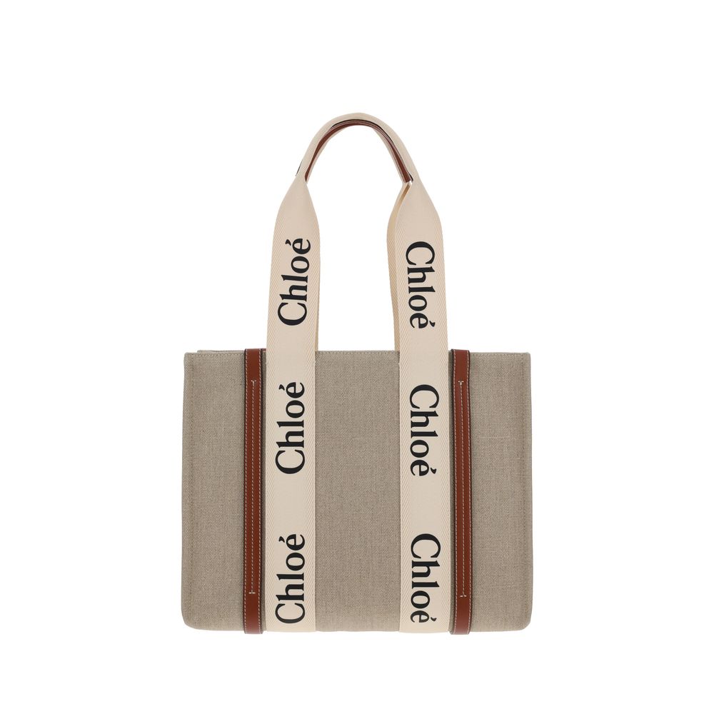 Chloé Medium Woody tote bag in white linen canvas and brown shiny calfskin leather trim featuring the signature Chloé logo ribbon.