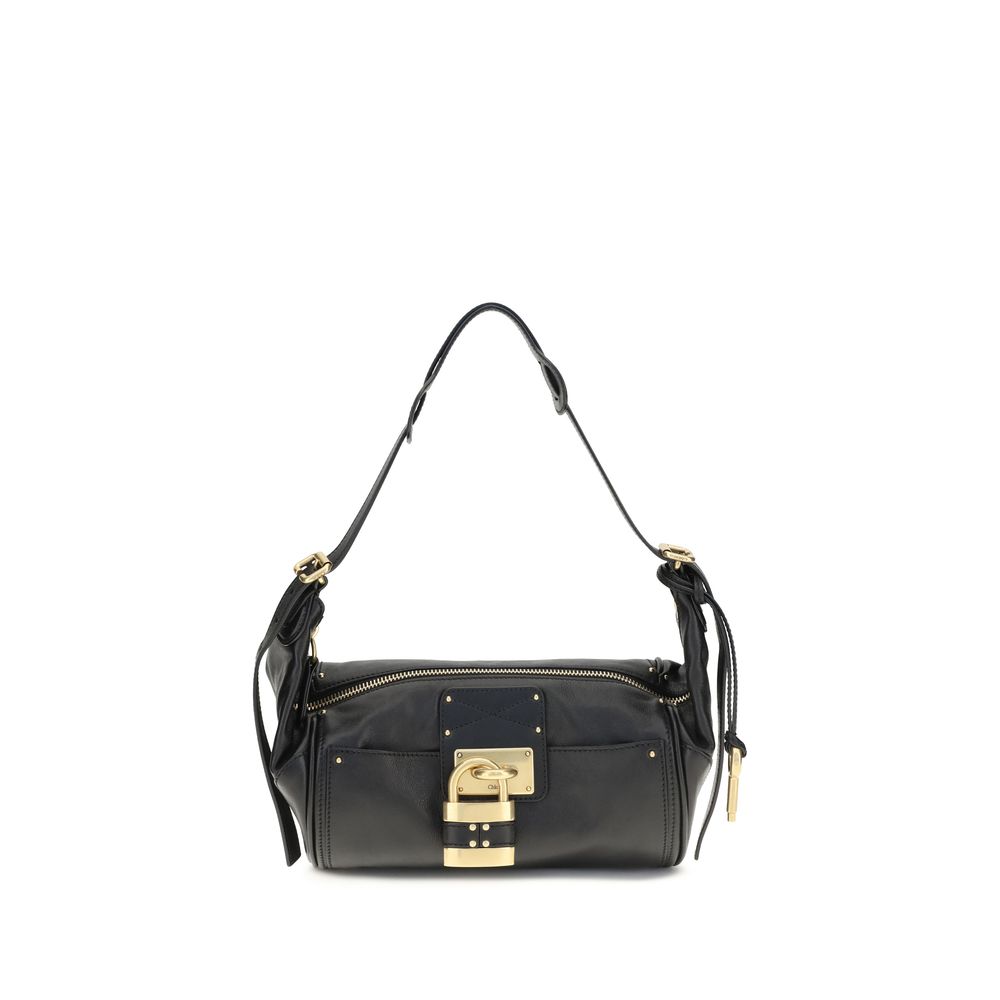 Chloé Paddington crossbody bag in black calf leather featuring a contemporary silhouette, iconic oversized padlock, gold-tone studs, and C-shaped buckles.