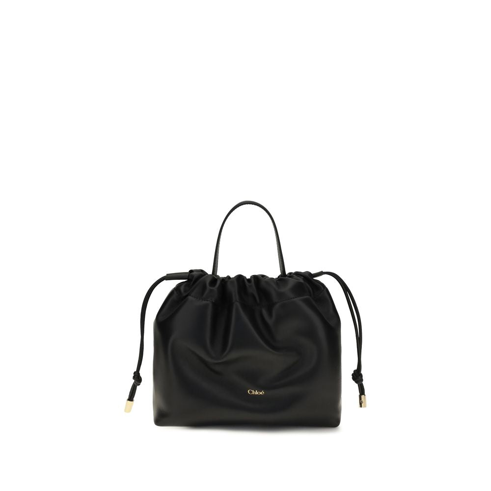 Chloé Icons small shoulder bag in black nappa lambskin featuring a drawstring closure and a gold-tone charm chain with a signature Horse Medal from The Exclusive Line Singapore.