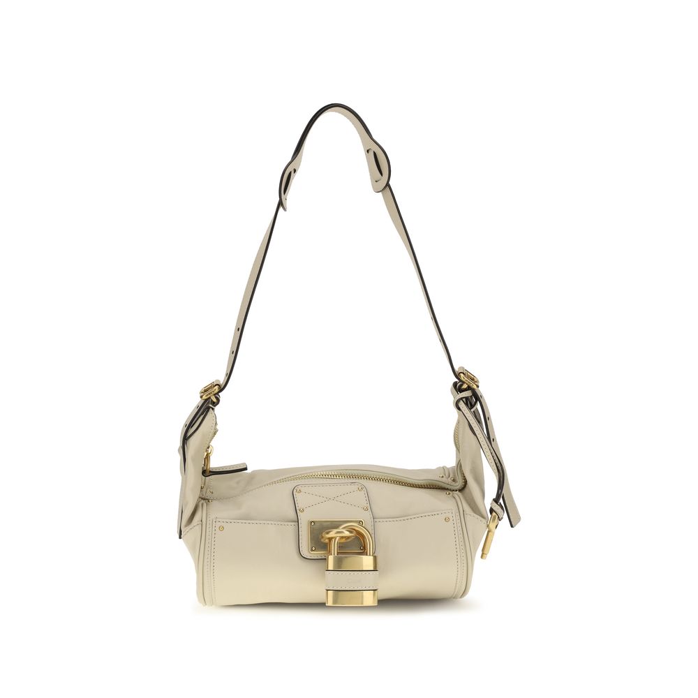 Chloé Paddington crossbody bag in cloudy cream calf leather featuring a contemporary silhouette, iconic oversized padlock, gold-tone studs, and C-shaped buckles.