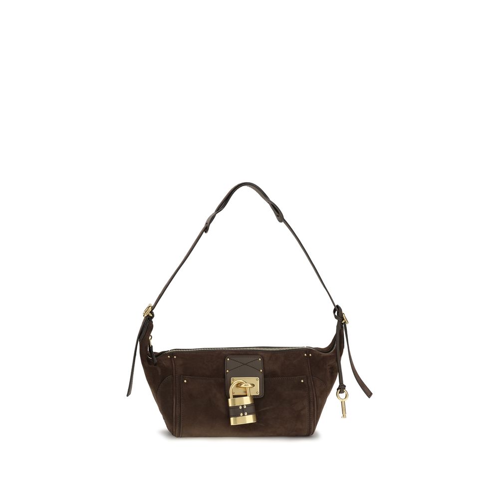 Chloé Paddington crossbody hobo bag in kohl brown suede calfskin leather featuring the iconic oversized metal padlock, studs, and an adjustable shoulder strap from The Exclusive Line Singapore.