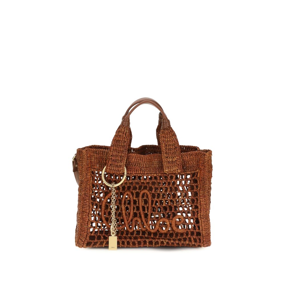 Chloé Small Summer Banana east-west tote bag in hand-crocheted dark brown raffia and buffalo leather trim with an artisan handwritten signature and dangling charms.