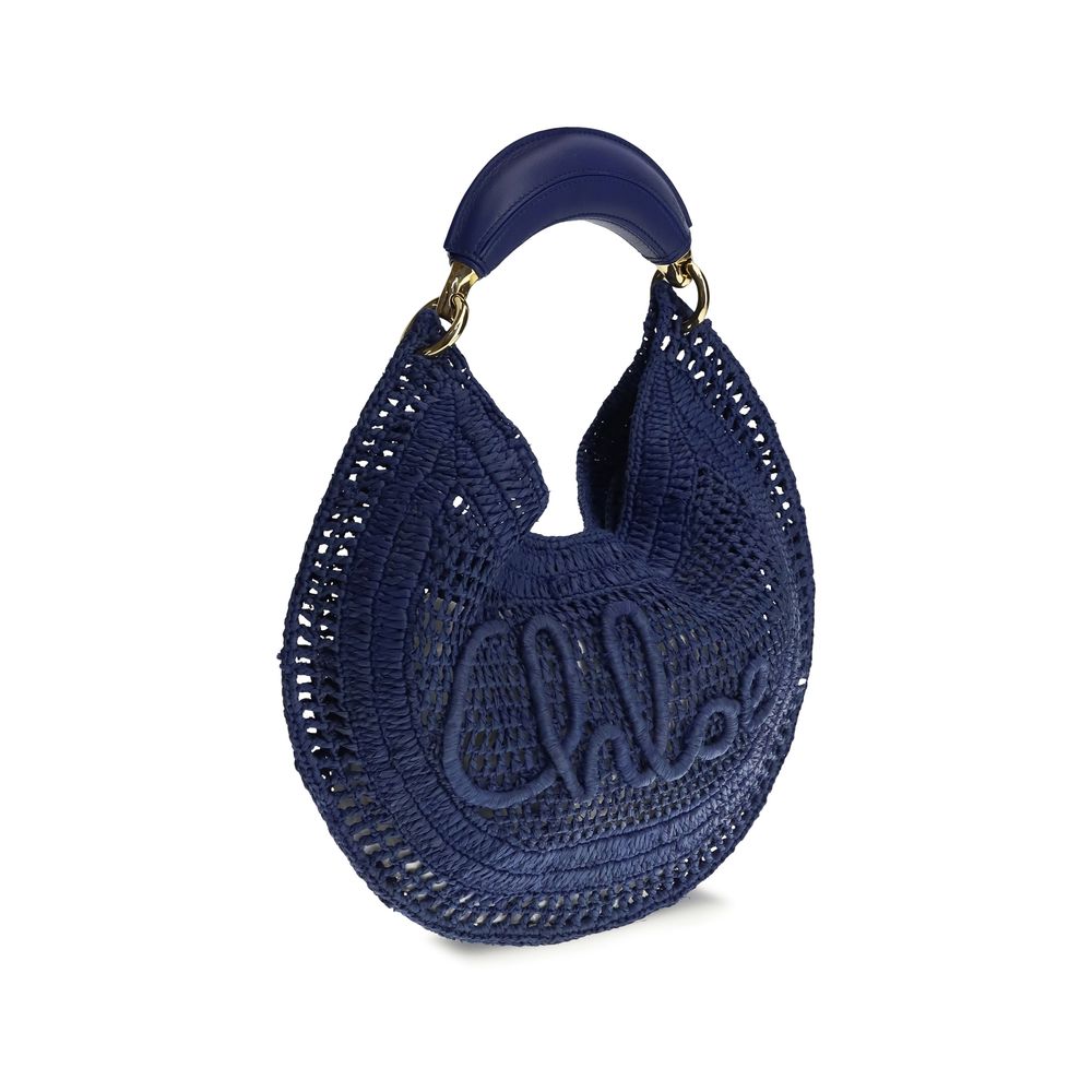 Side view of Chloé Summer Banana Hobo Bag - Midnight Blue Raffia from The Exclusive Line Singapore.