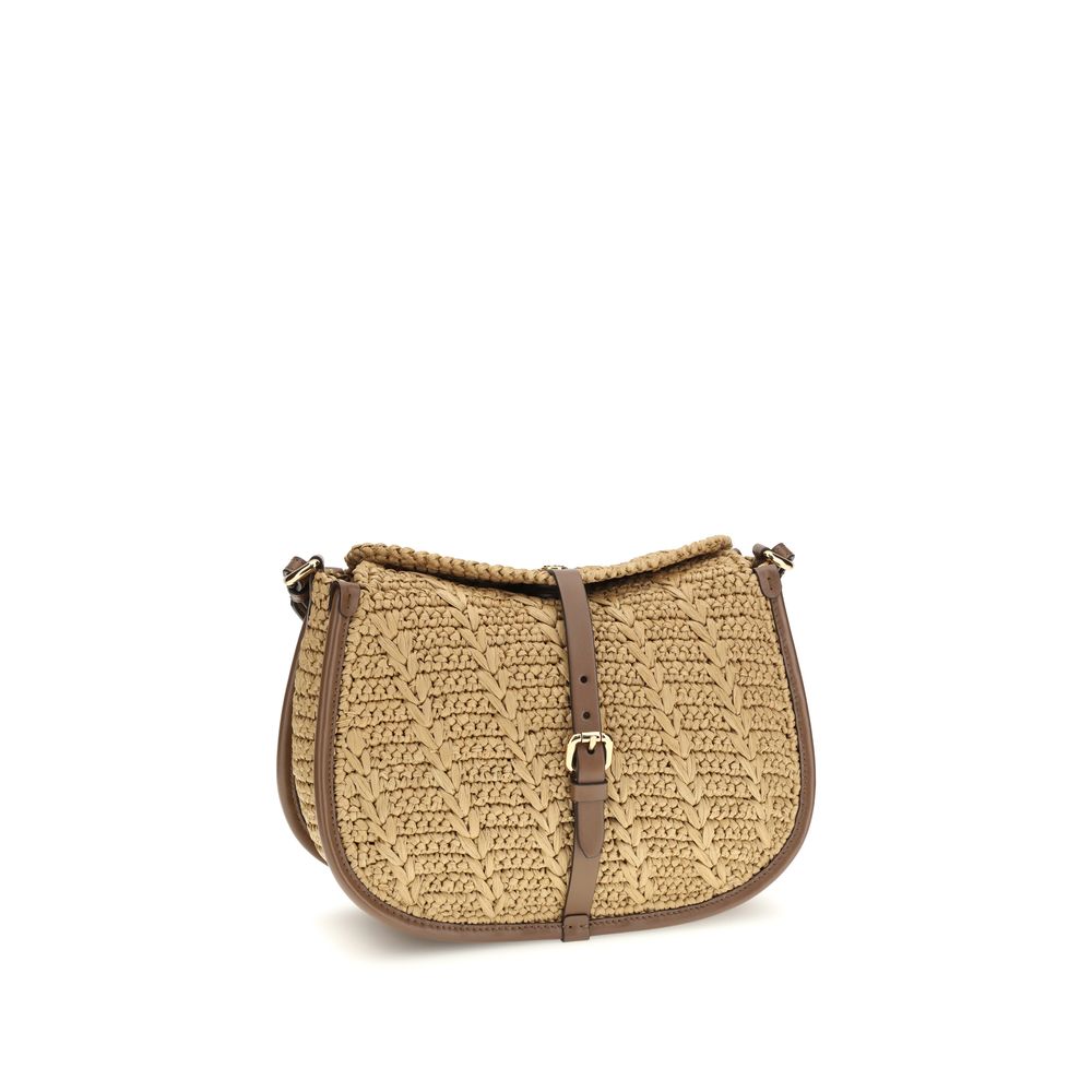 Side angle of Etro Medium Pony Bag in brown crocheted raffia and calfskin leather—available at The Exclusive Line Singapore.