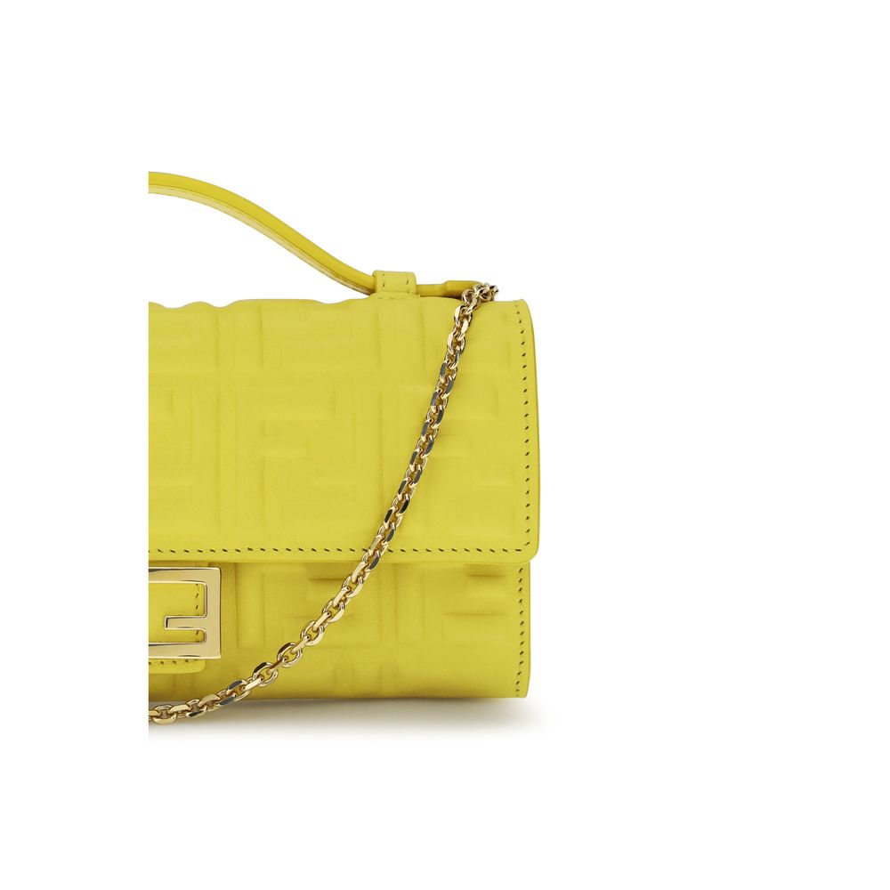 Close up of Fendi Baguette Continental Wallet in Broom Yellow embossed nappa leather with gold FF clasp, available at The Exclusive Line, Singapore.