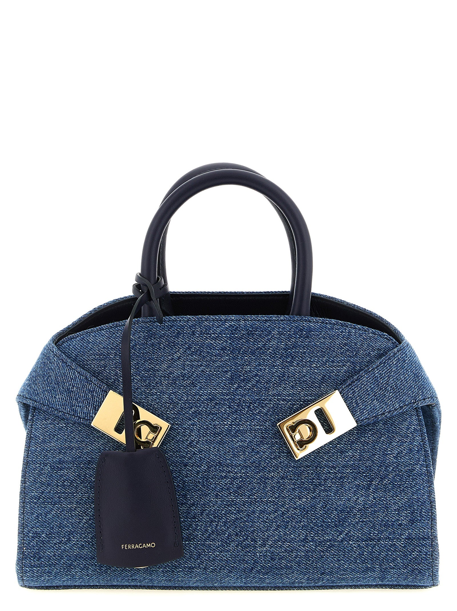 Ferragamo Hug XS handbag in blue denim with tonal leather accents and gold Gancini buckles.