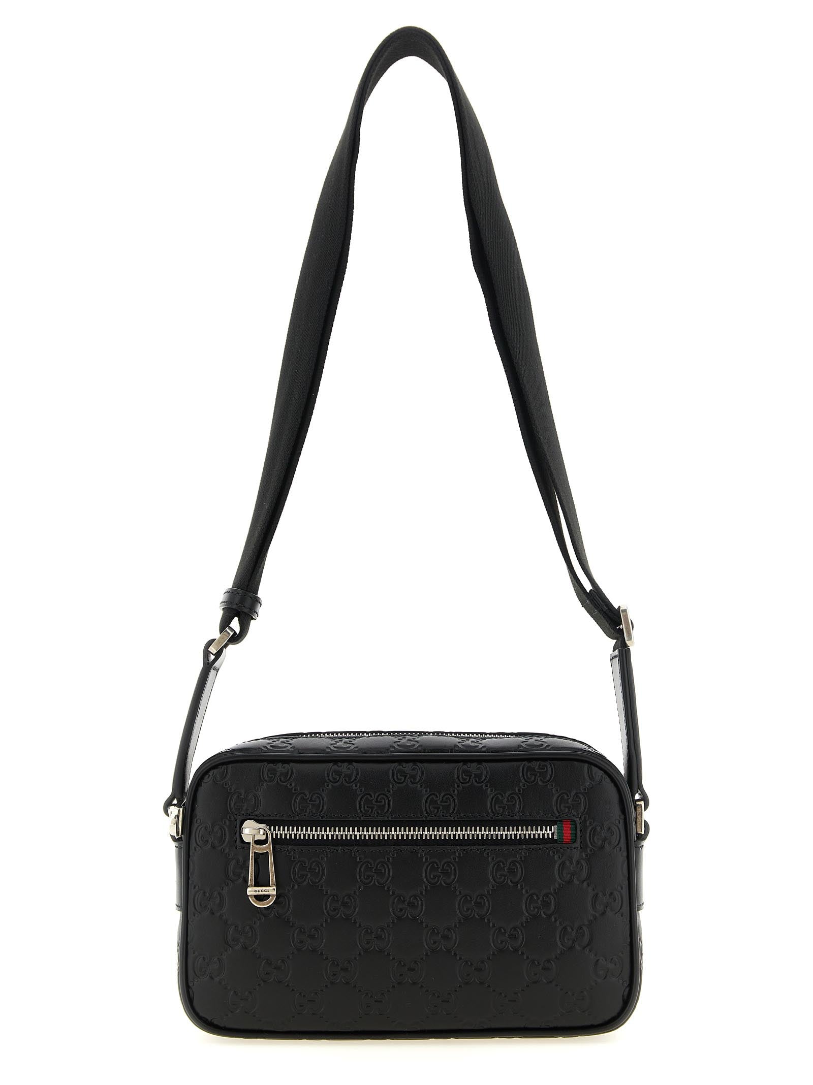 Gucci GG Emblem Small Crossbody Bag in black embossed GG smooth leather with web detail and adjustable canvas strap.