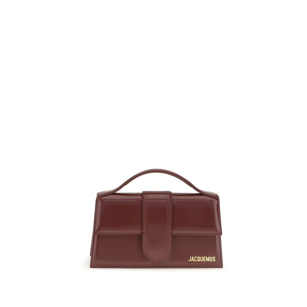Jacquemus Le Grand Bambino flap bag in burgundy patent calf leather with gold-tone logo lettering and structured top handle.
