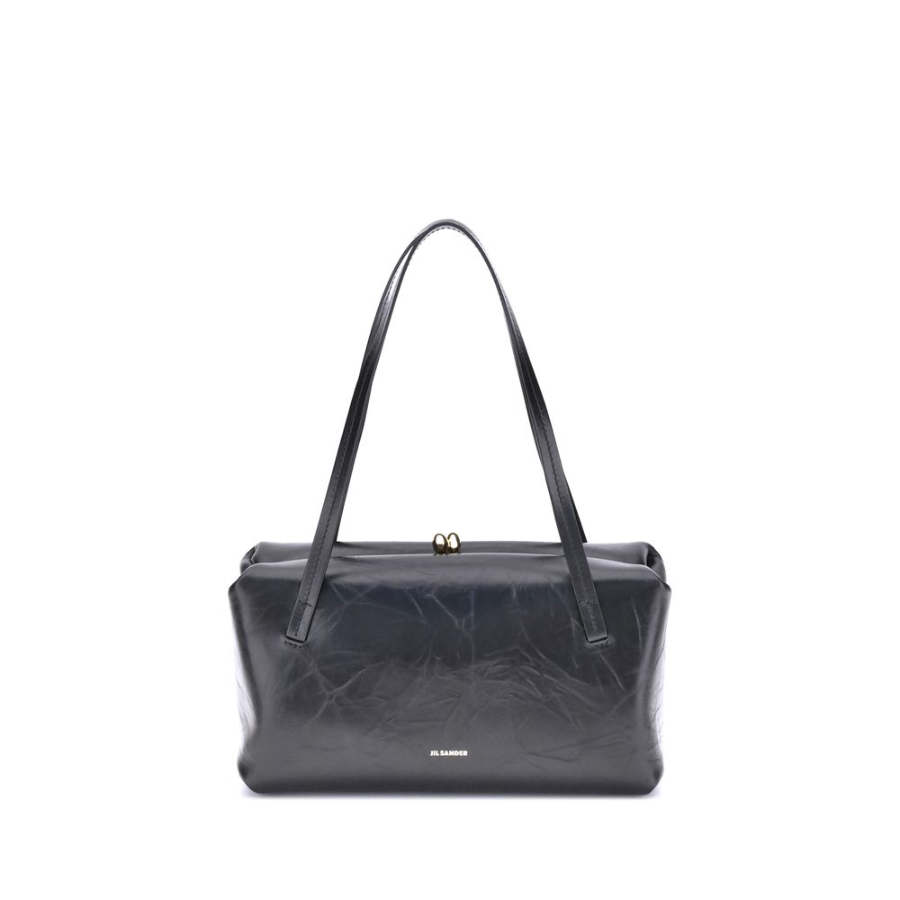 Jil Sander Goji Pillow Small black leather shoulder bag with puffy rectangular shape and metal frame closure.