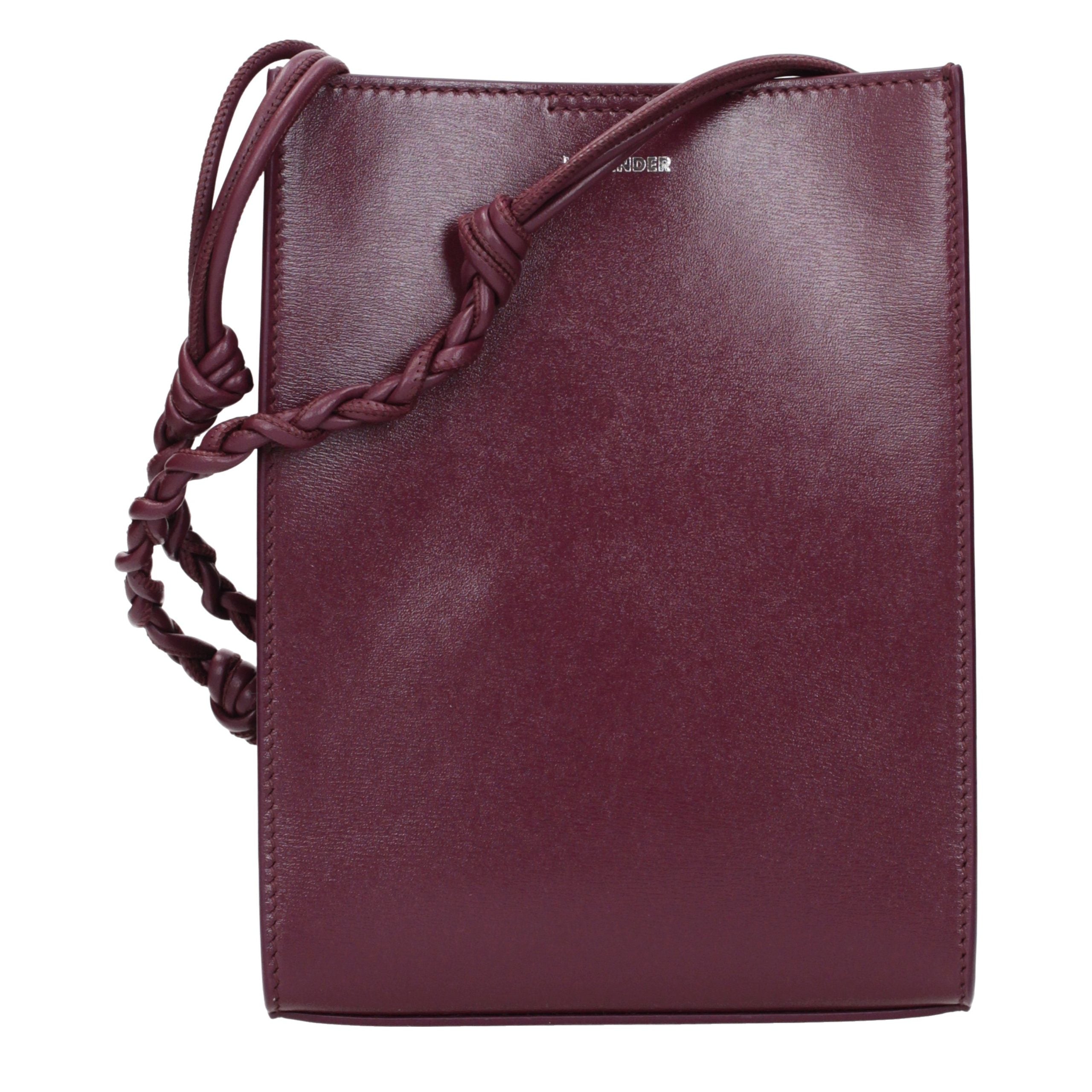 Jil Sander Tangle Small Shoulder Bag in red orchid calf leather featuring a hand-knotted shoulder strap.