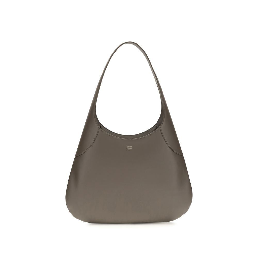 Side view of the oversized Khaite Joan Large Hobo Bag in elephant gray calfskin, showcasing its generous draped volume and integrated strap.