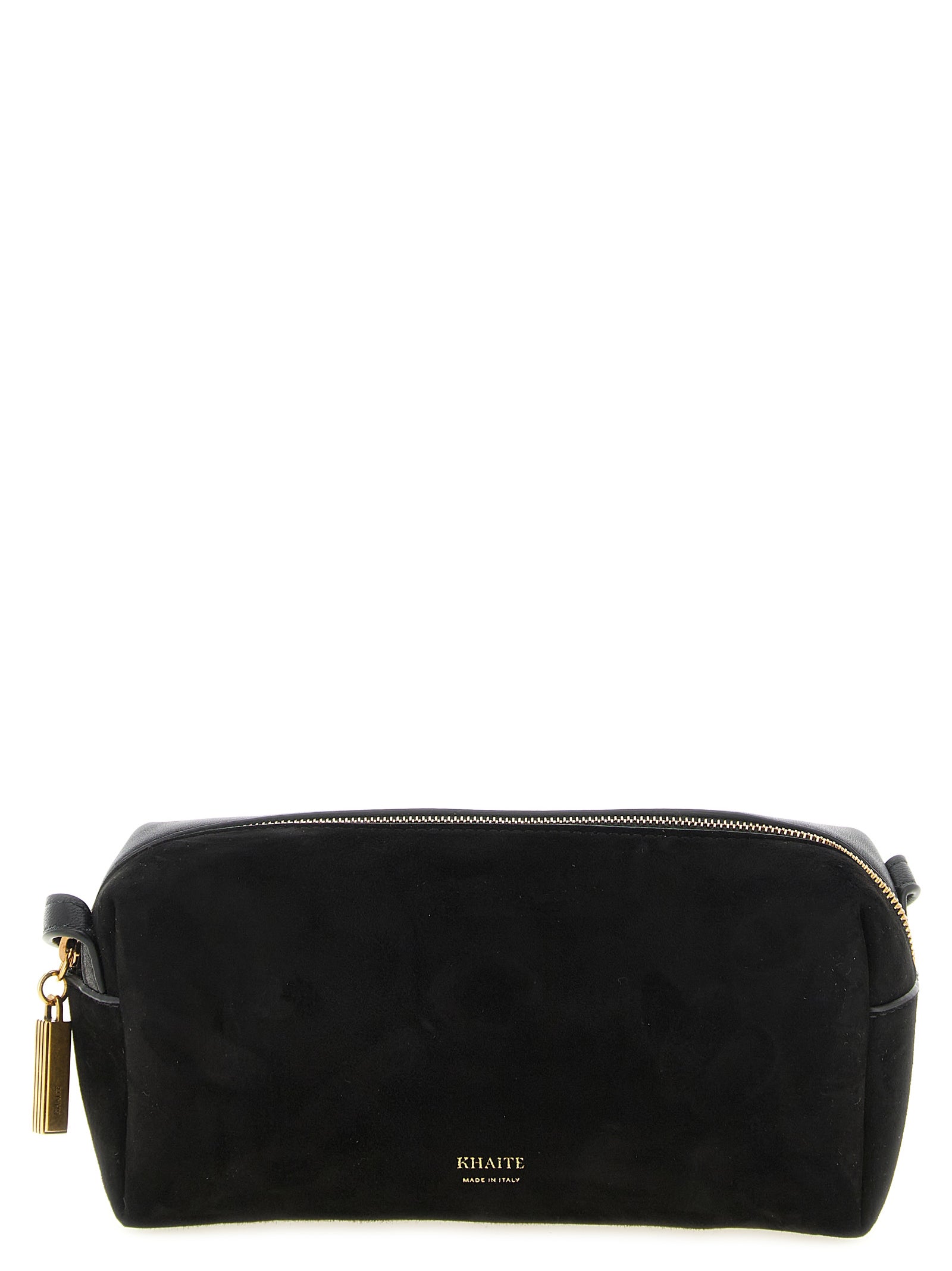 Khaite Kye Mini Crossbody Bag in black, showing the elegant contrast between the soft suede front panel and smooth calfskin leather back, complete with an adjustable strap, top zip, and a dangling gold padlock charm.