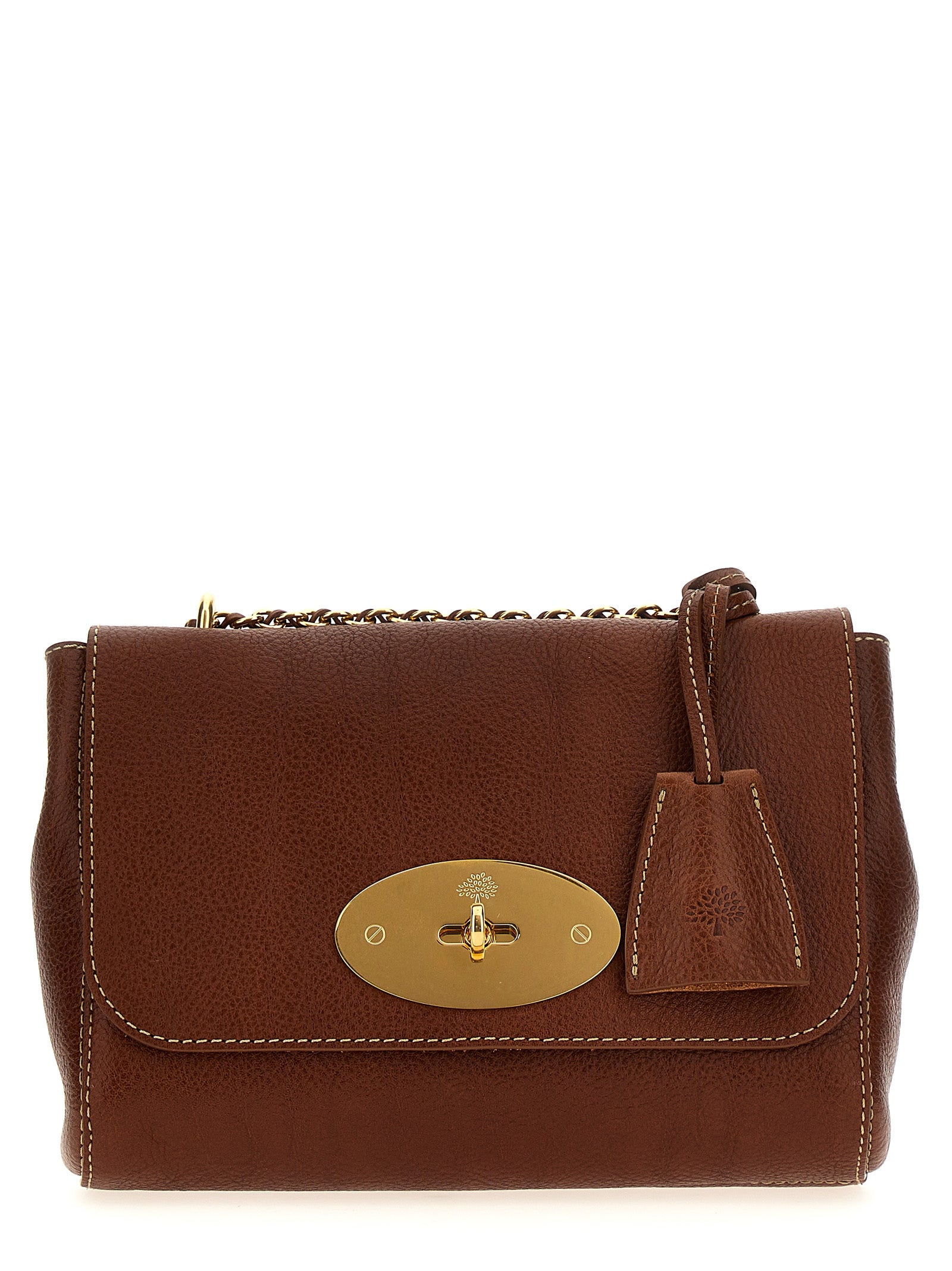 Mulberry Small Lily evening bag in Oak small classic grain leather featuring a brass Postman’s Lock, a woven leather chain strap, and a hanging padlock fob from The Exclusive Line Singapore.