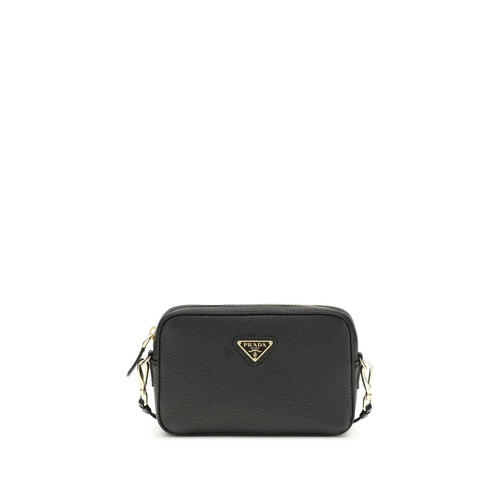 Prada Black Leather Mini Bag with gold hardware and enameled triangle logo, available at The Exclusive Line Singapore.
