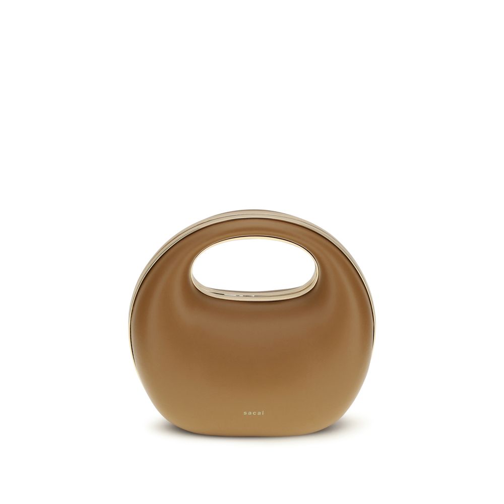 Sacai Round Leather Handbag in Camel featuring a rigid handle and brass hardware, curated by The Exclusive Line Singapore.