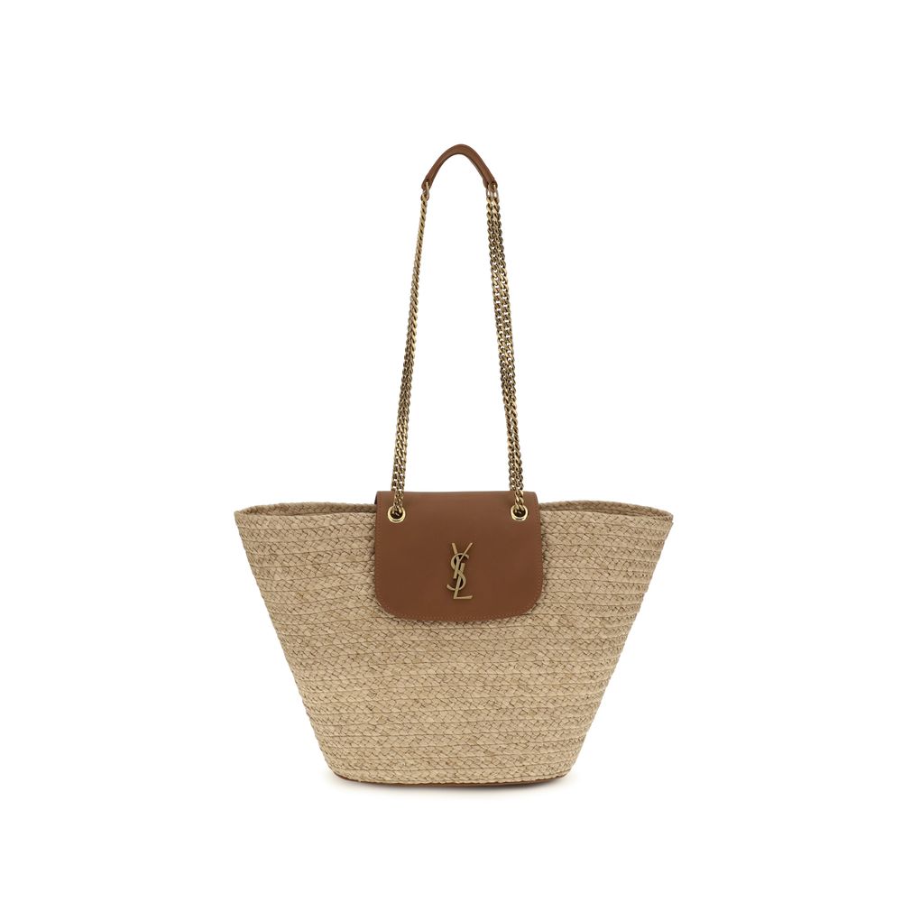 Saint Laurent Manon basket shoulder bag in natural woven raffia featuring a brown leather flap and bronze CASSANDRE logo from The Exclusive Line Singapore.
