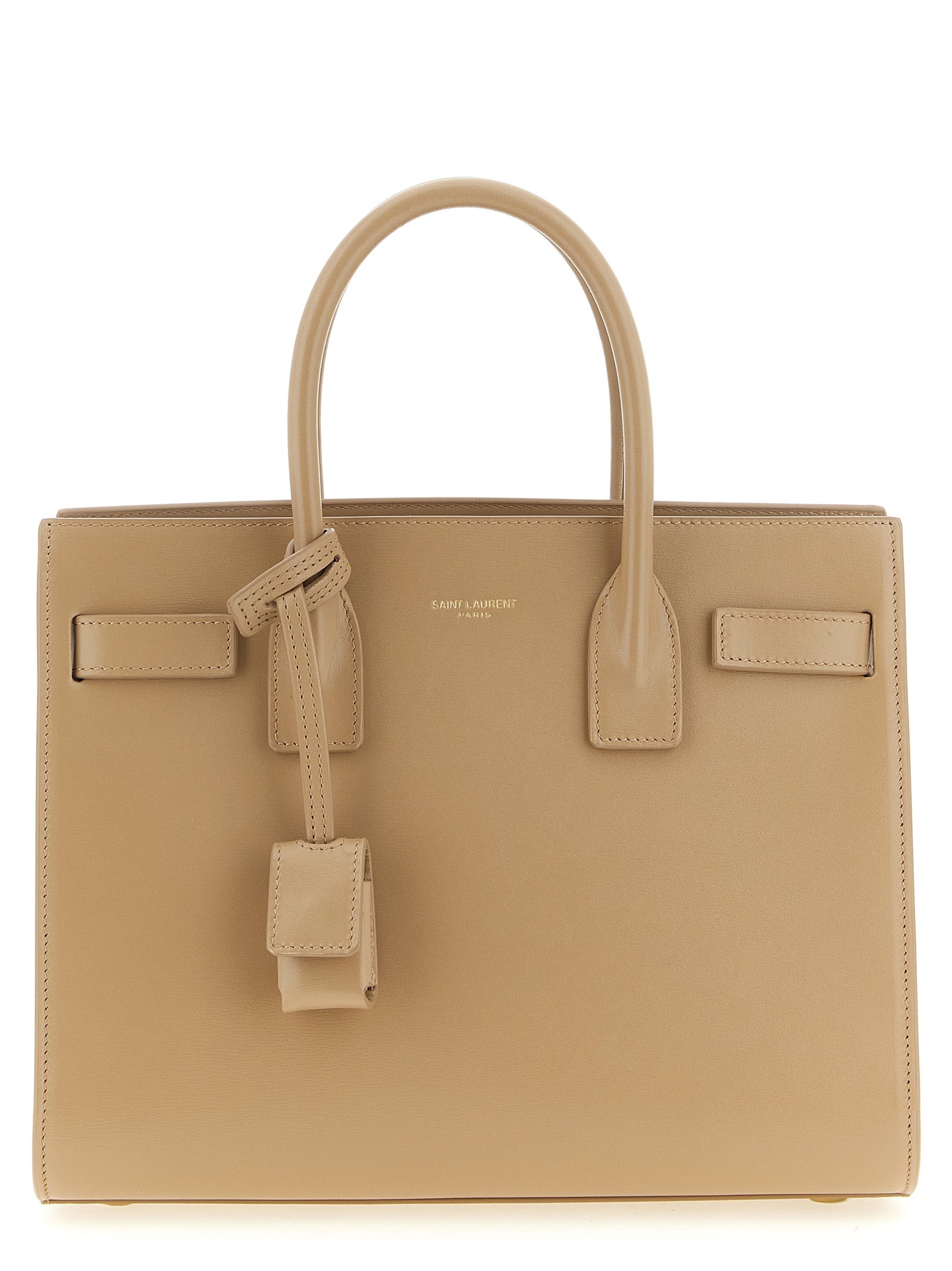 Saint Laurent Sac De Jour Baby tote bag in beige grained calfskin leather featuring signature accordion sides and a light bronze padlock case from The Exclusive Line Singapore.