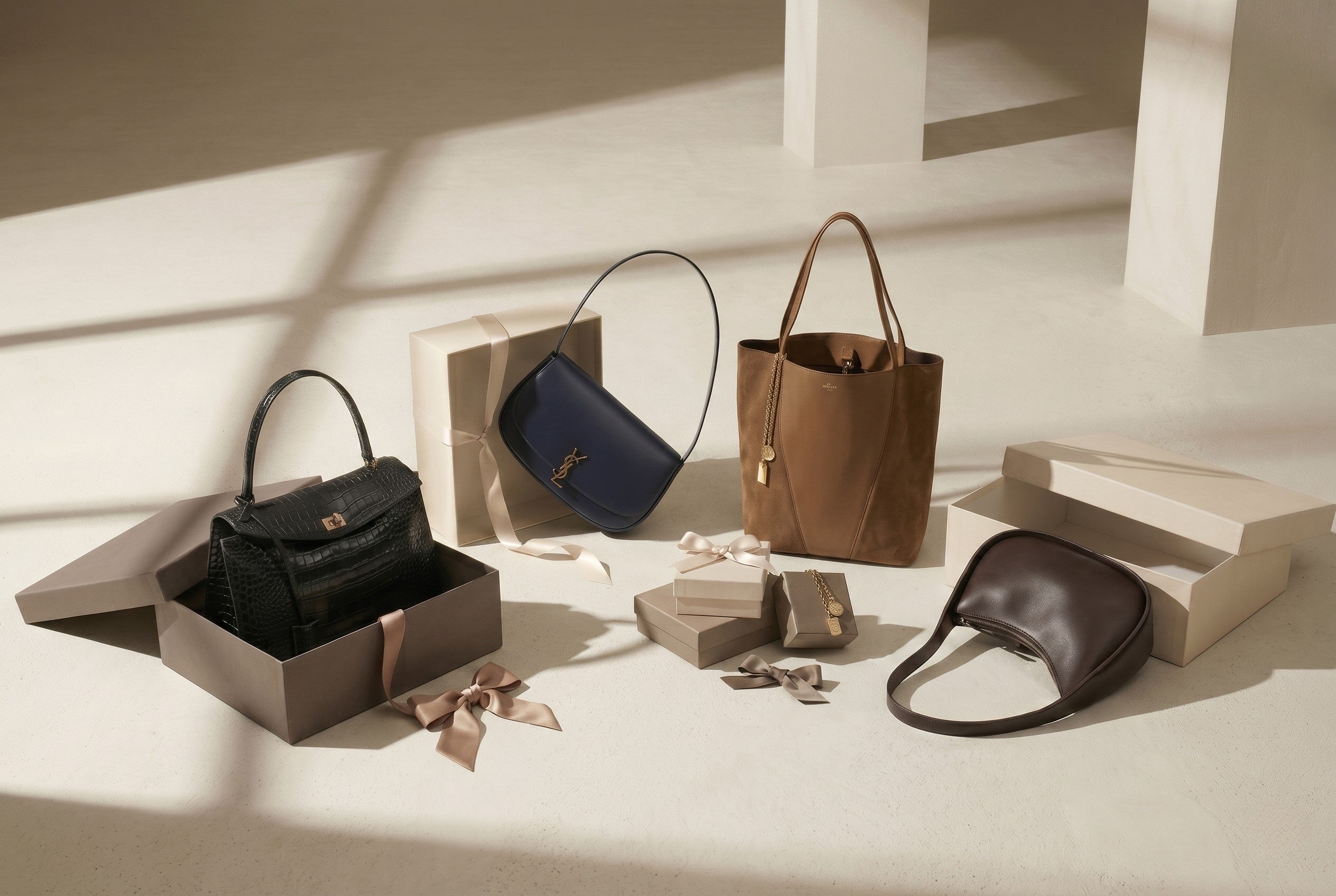 Left: Balenciaga Rodeo Handbag in Croc Embossed, Center-Left: YSL Black Shoulder Bag, Center-Right: Chloé Spin Tote in Brown Leather & Suede, Right: Dark chocolate brown leather bag