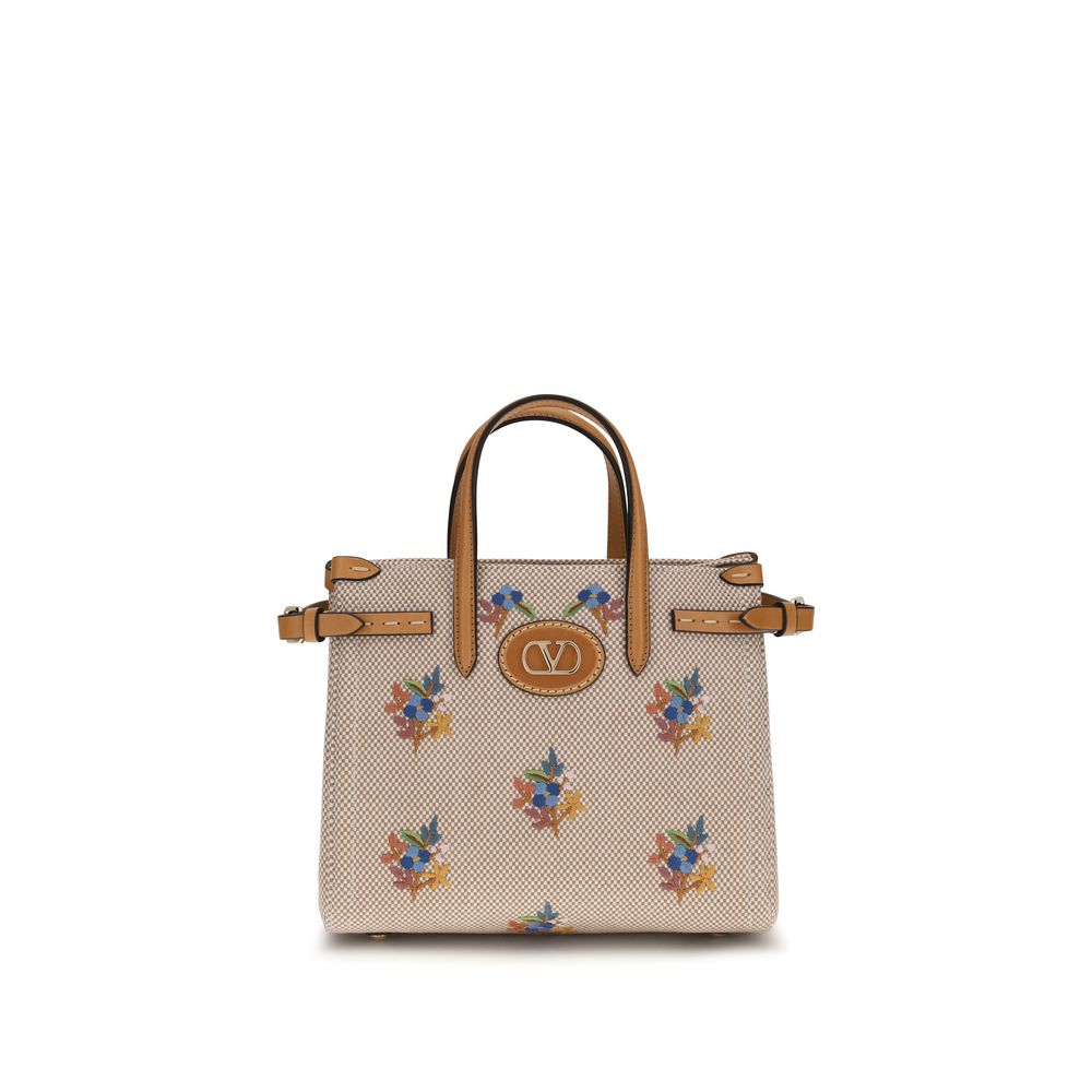Valentino Garavani Antibes small shopping bag in natural canvas with floral embroidery and gold VLogo Signature detail.