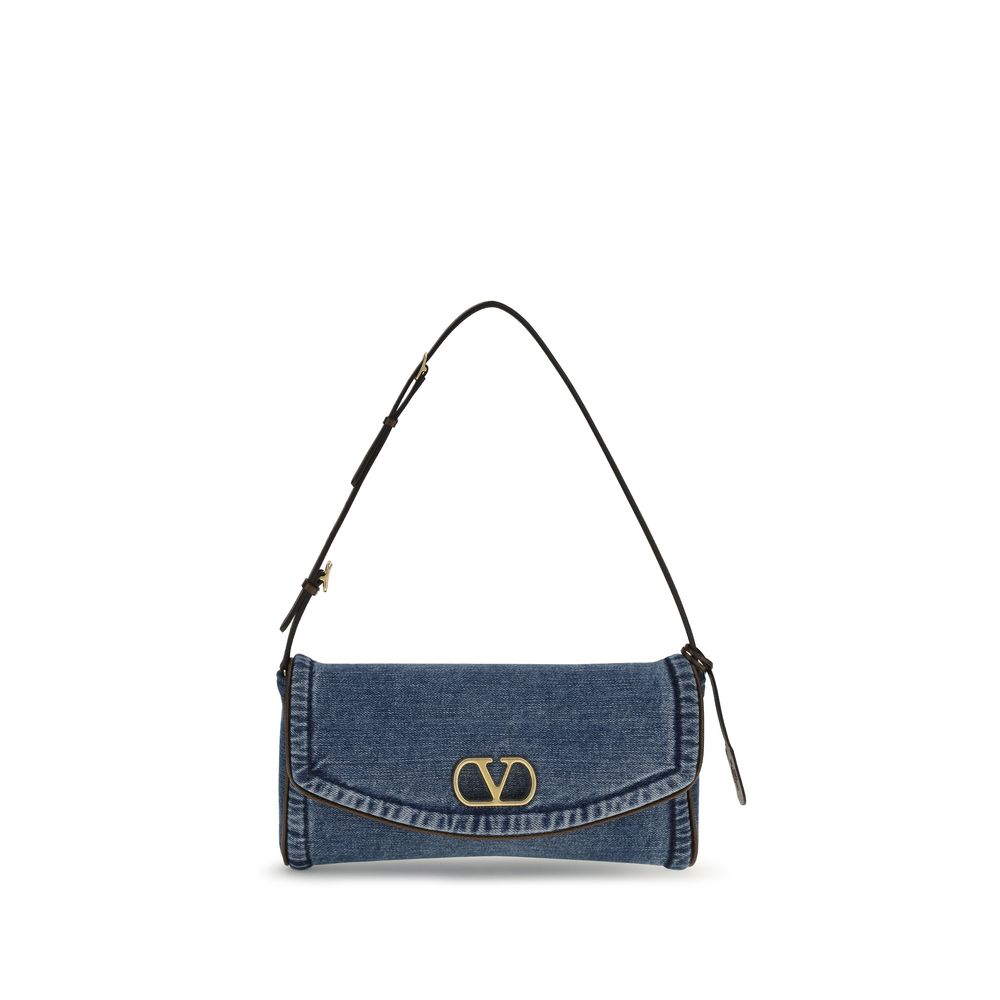 Valentino Garavani DeVain small shoulder bag in denim and grainy calfskin with antique brass VLogo magnetic closure.