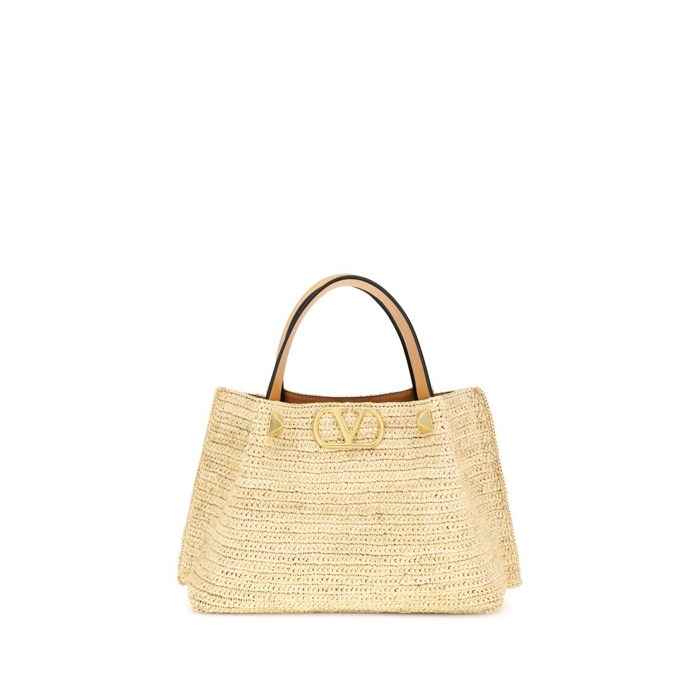 Valentino Garavani Small Shopping Bag in Natural Raffia with Antique Brass VLogo Signature - available at The Exclusive Line Singapore.