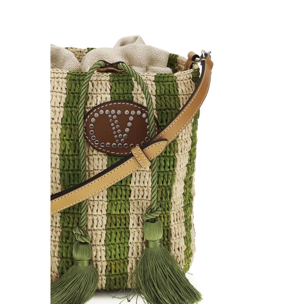Close up of Valentino Garavani Small Bucket Bag in Natural and Green Striped Raffia with VLogo Leather Patch