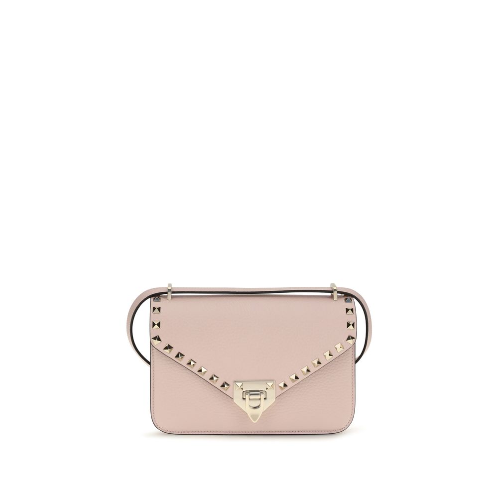 Valentino Garavani Rockstud small shoulder bag in pink grainy calfskin leather with platinum studs and hook closure.